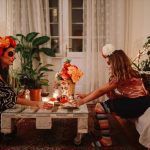 Mom celebrating Day of the dead with her daughter at home